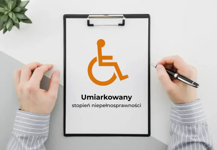 Na tablicy widnieje symbol osoby na wózku inwalidzkim i napis "Umiarkowany stopień niepełnosprawności".