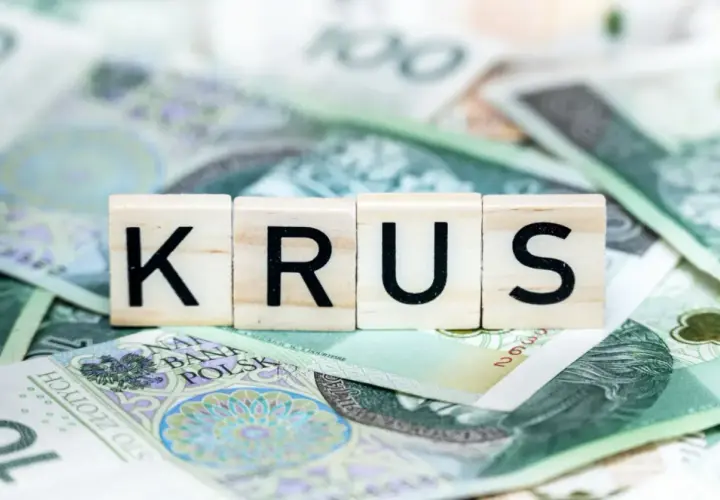 Litery K, R, U, S na tle polskich banknotów. Symbolizują dodatki do renty z tytułu całkowitej niezdolności do pracy.